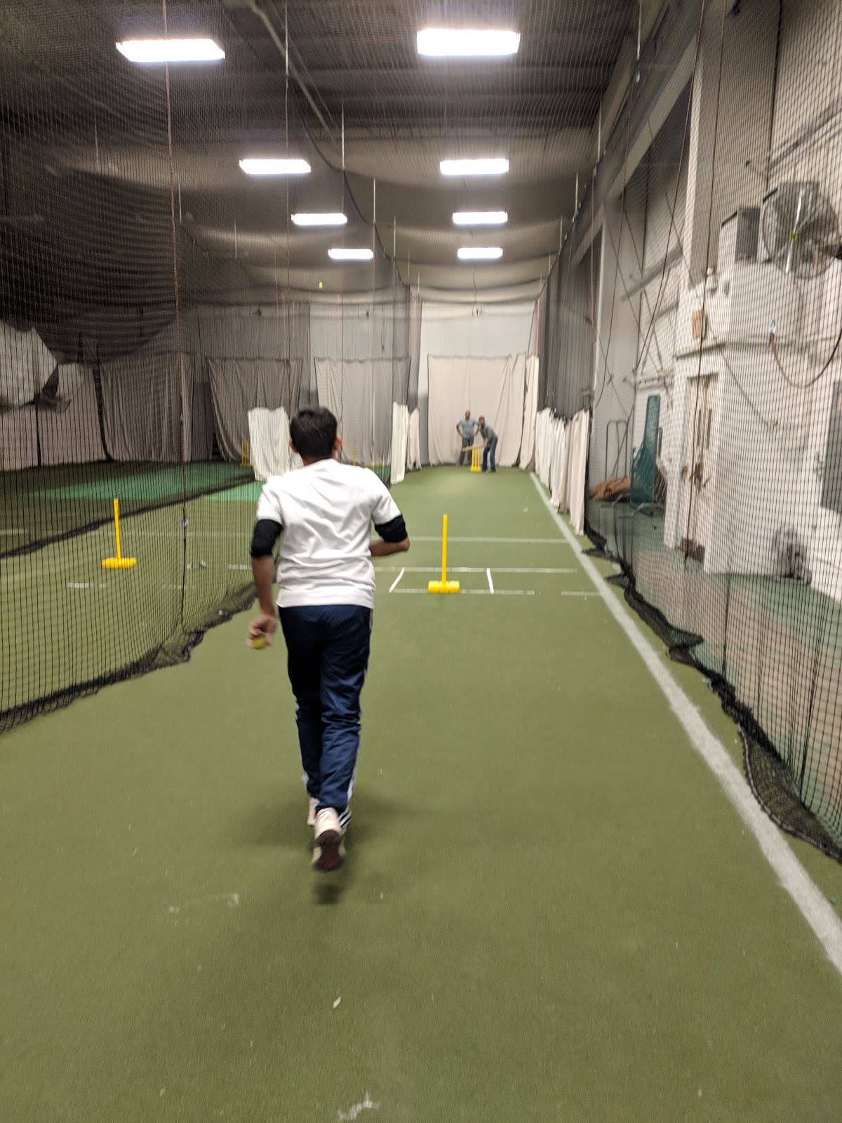 A bowler running in on a full-length lane