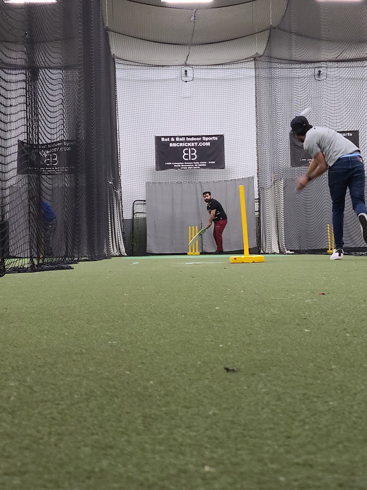 A BBCL match in play, batter at the crease and bowler mid-delivery