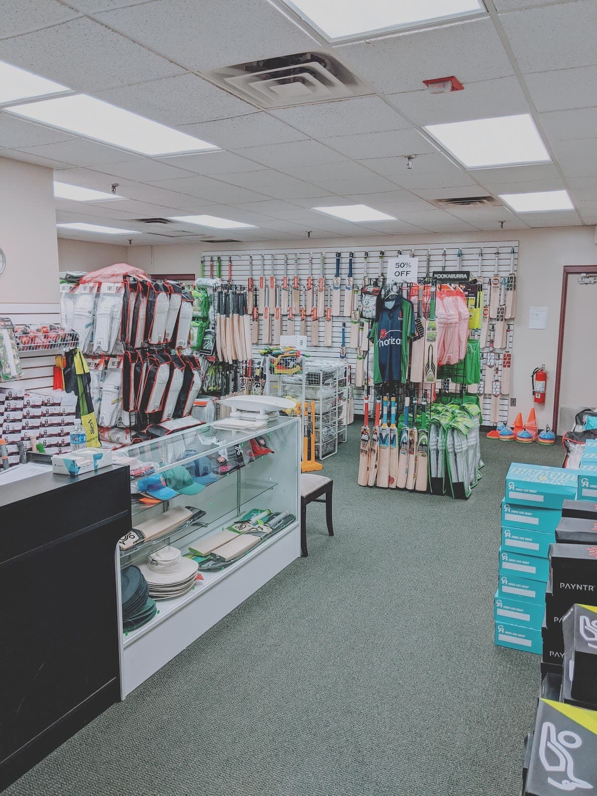 The pro shop at Bat x Ball, bats and gear along the wall